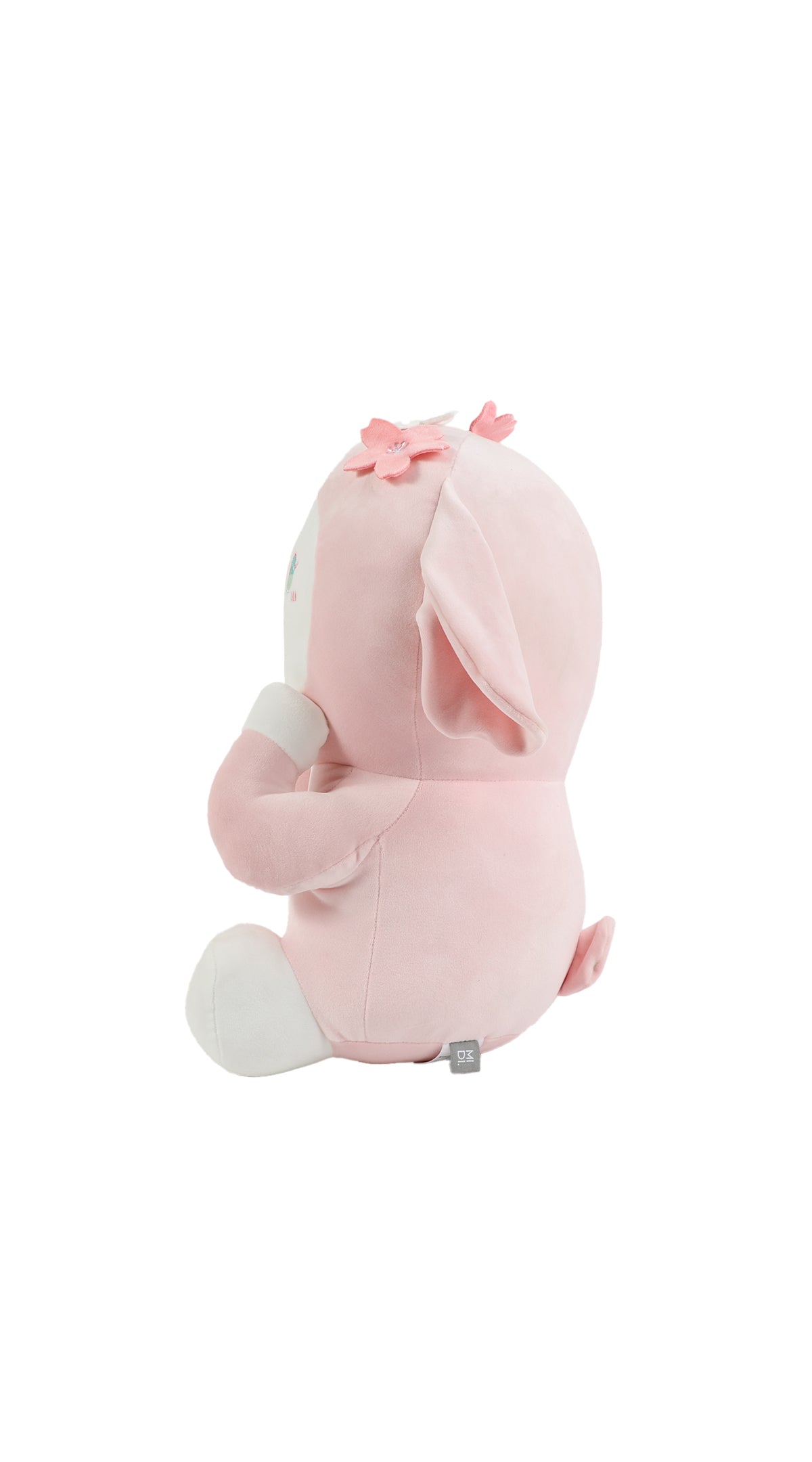 Pink plush rabbit lying pose, side view with bow on head and long ears.