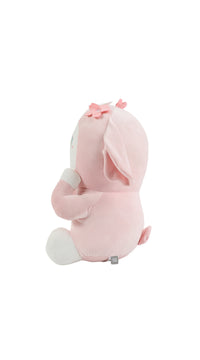 Pink plush rabbit lying pose, side view with bow on head and long ears.