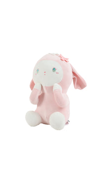 Pink plush rabbit sitting, flower bow on head, long ears and round feet.