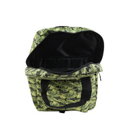 Green fish-print backpack with open top revealing black-lined interior pocket