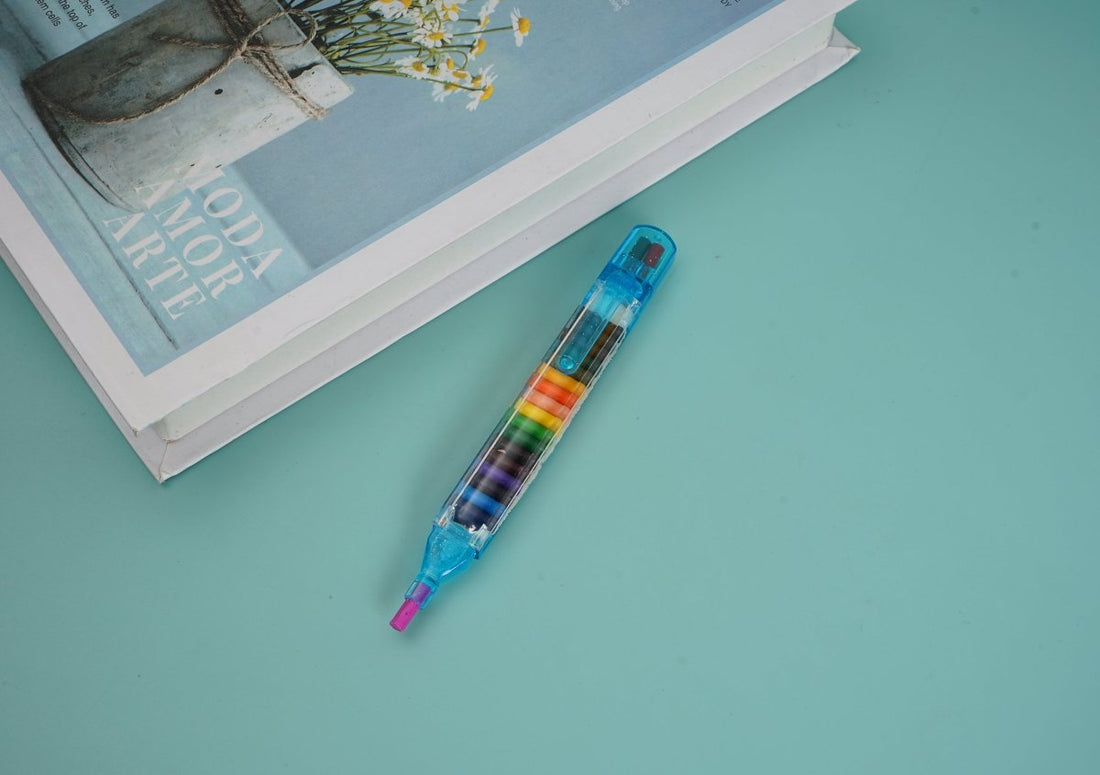Multi-crayon pen with clear blue body and colored crayon tips