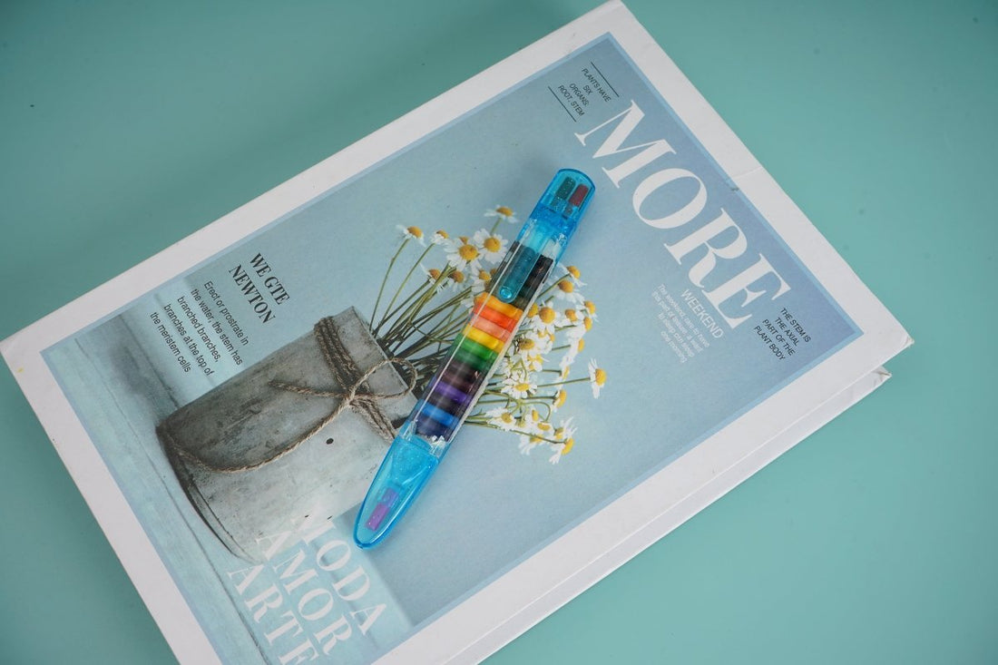 Transparent blue multi-crayon pen with rainbow color chambers