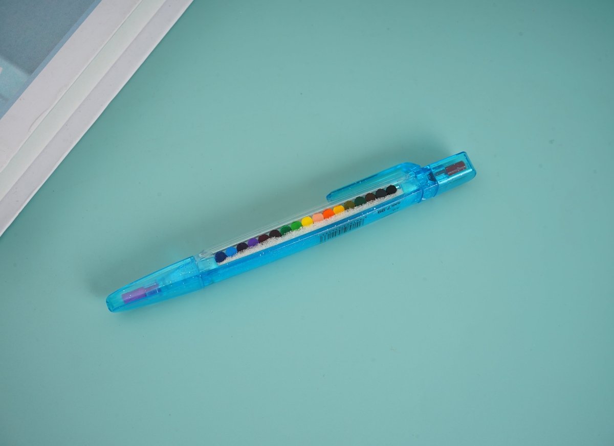 Blue retractable-style multi-crayon pen with rainbow tip section