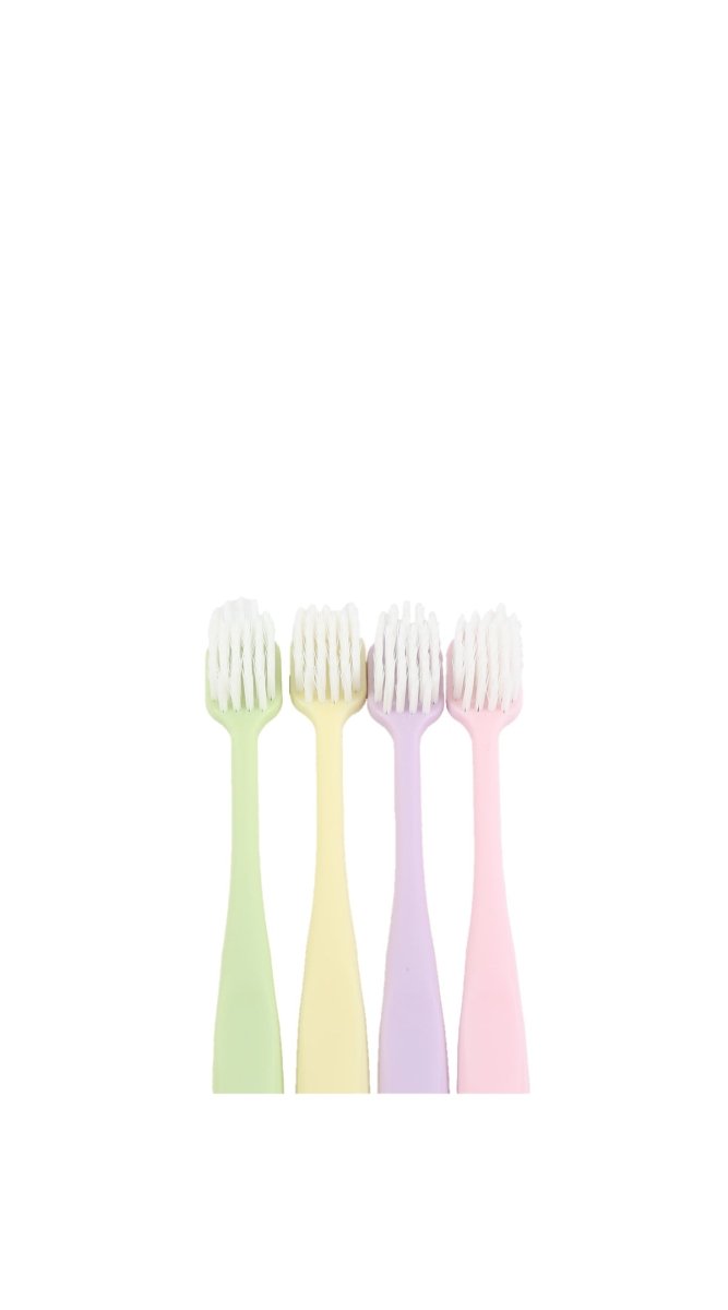 Soft toothbrush heads with short bristles on pastel handles, front view