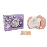 Pink camera-shaped handheld fan with round grille, control buttons, and sticker sheet