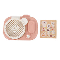 Pink camera-shaped handheld fan with round front grille and included sticker sheet