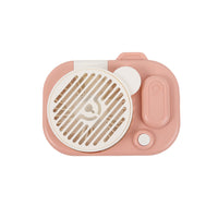 Pink camera-shaped handheld fan with round front grille and raised side control panel