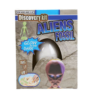 Alien fossil discovery kit box with glowing dark dig graphic and purple alien fossil