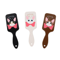 Three cat-themed square hair brushes in black, off-white, and brown with pink bow designs