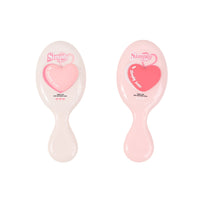 Two oval cushion hair brushes: off-white and light pink, each with heart graphic