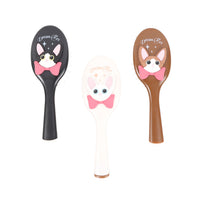 Set of oval cushion hair brushes in black, off-white, and brown with cat-face handles