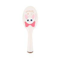 Off-white oval cushion hair brush with cartoon cat face and bow on handle