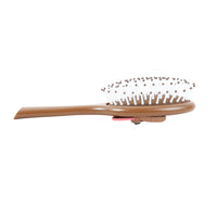 Brown oval cushion hair brush with round pin bristles on top