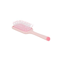 Pink square cushion hairbrush with dense bristle pad and short handle