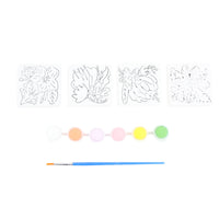 Ceramic magnet set with four white outline designs; colored paint daubs and blue brush