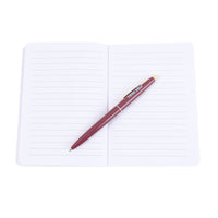 Open white lined notebook with maroon pen resting on right page