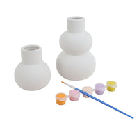 White ceramic vase painting kit featuring two vases, small paint pots, and blue brush