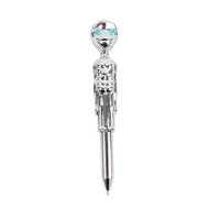 Chrome decorative ballpoint pen with teal gem top and downward writing tip