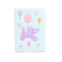 Light blue TPU notebook cover with purple balloon animal, pink balloons, and heart shapes