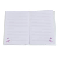 Open light blue notebook with purple ruled pages and small balloon icons near corners