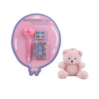 Pink plush bear keychain beside stationery set with notebook and pen