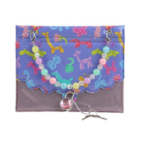 Hard-cover notebook with purple glitter base, floral bead charm and snap clasp