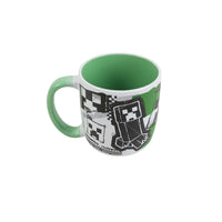 13oz ceramic mug with green handle and black-and-white pixel characters graphic