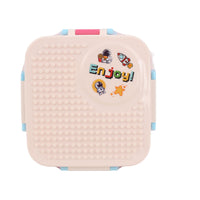 Pink and cream building-block style lunch box with blue corner latches and front graphic