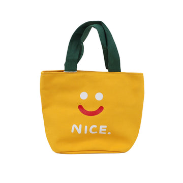 Yellow handheld lunch bag with green handles, smiley face and 'NICE.' print