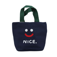 Navy handheld lunch bag with green handles, smiley face and 'NICE.' print