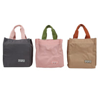 Handheld lunch bag assortment with dark gray, pink, and beige styles in one view.