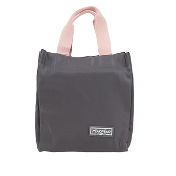 Dark gray handheld lunch bag with pink handles and logo patch on front.