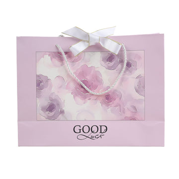 Light pink large gift bag with rope handles, floral print and 'GOOD Luck' text