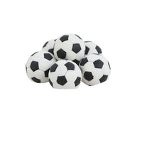 Pile of soccer ball-shaped erasers, white with black pentagon patches