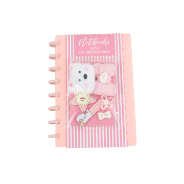 Pink DIY notebook with six silicone charms on front cover, spiral binding