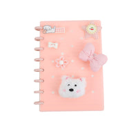 Pink notebook cover with silicone charms: bear face, bow, flower and cloud, spiral