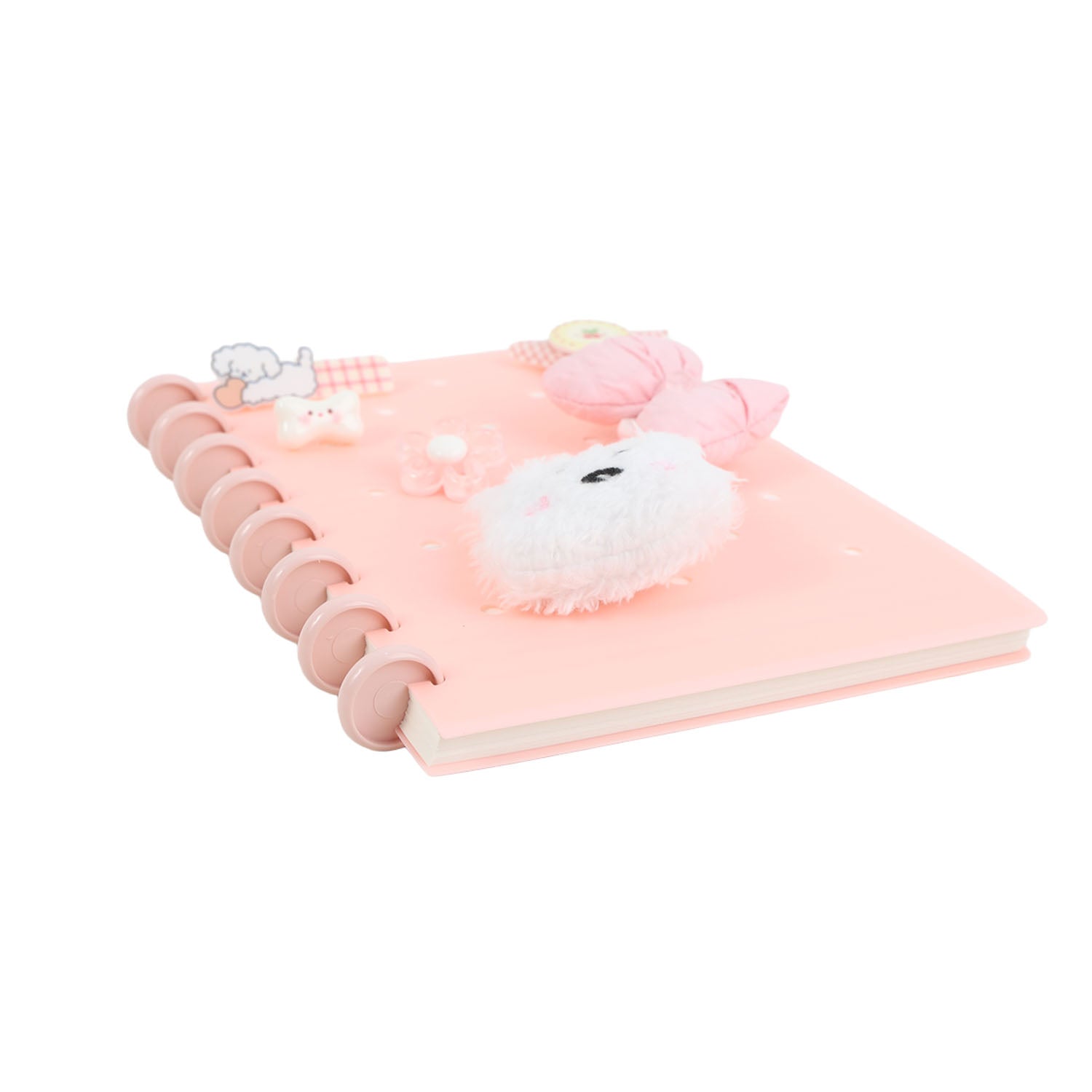 Pink spiral notebook with silicone charms on front cover, angled view