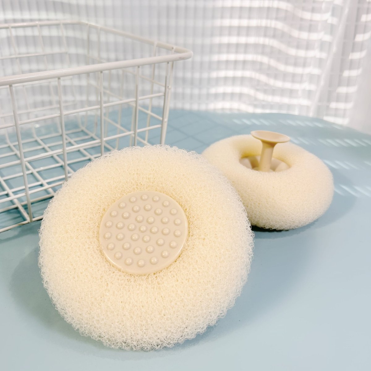 Cream cleaning sponge set with large and small circular textured scrub pads and soap holders.