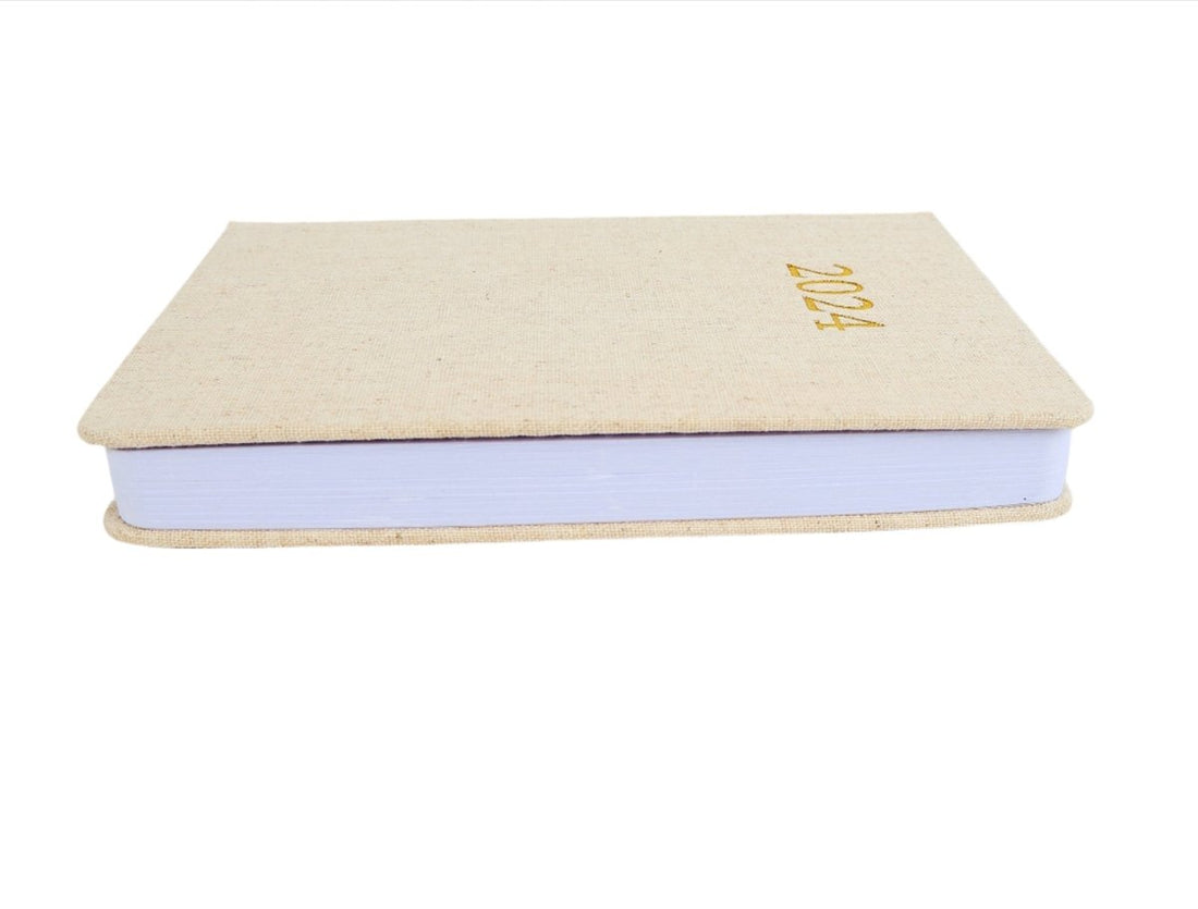 Linen daily planner with '2024' foil on cover and blue pages