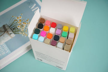 Double-ended watercolor pen set in open box with multicolor caps and nibs