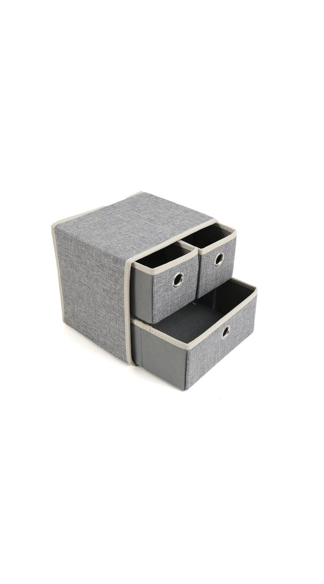 Grey fabric drawer organizer with two drawers exposed and one compartment closed