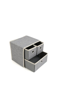 Grey fabric drawer organizer with two drawers exposed and one compartment closed