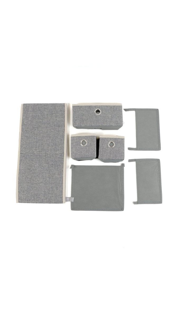 Grey fabric organizer with three open drawer fronts and separate storage bins