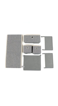 Grey fabric organizer with three open drawer fronts and separate storage bins