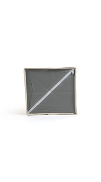 Grey fabric organizer with hinged lid closed and diagonal seam detail on top