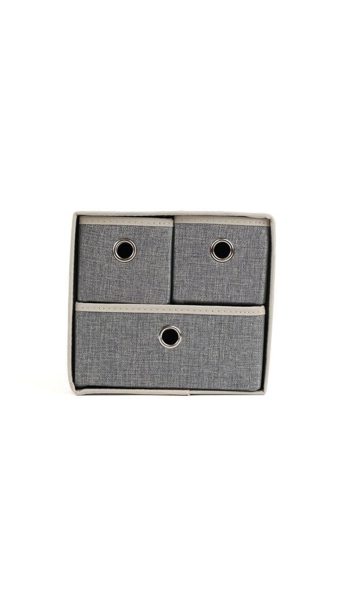 Grey fabric 3-bin organizer with circular cutout handles on three drawer fronts