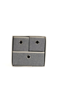 Grey fabric 3-bin organizer with circular cutout handles on three drawer fronts