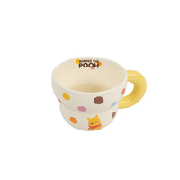Winnie the Pooh ceramic cup with yellow handle, cream base and multicolor dot pattern