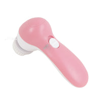 Pink 3-in-1 facial brush with bristle head and oval handle, side view