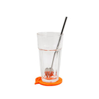 Clear glass drink cup with orange coaster and straight silver straw